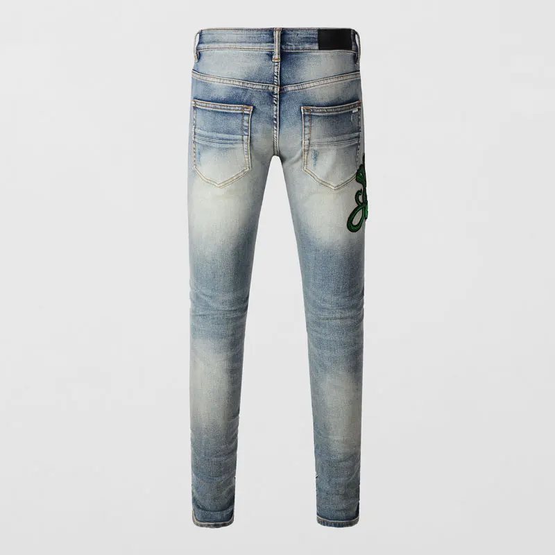 Fashionable new men's jeans, washed with water, nostalgic distressed patch, snake shaped pattern, light blue jeans, high street