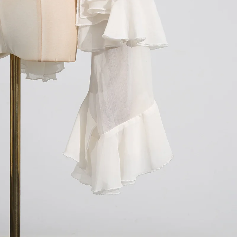 New style of the fashion season - elegant and stylish netted sleeveless top with wooden earflaps and long sleeves