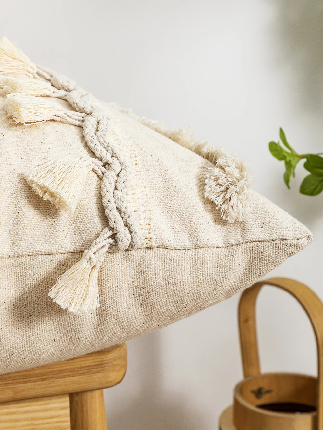 A beige triangular dot tassel pillow cover with European and American style tufting technology used for sofas, beds, bedrooms
