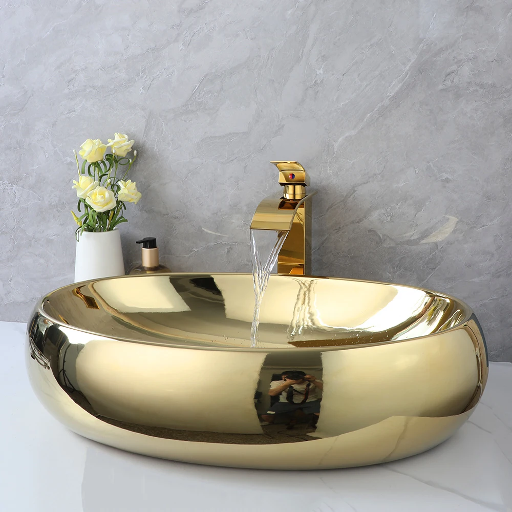 ZAPPO 23 Inch Bathroom Vessel Sink Gold Ceramic Sink Bowl Above Counter Oval Bathroom Sink with Waterfall Faucet Drain Combo