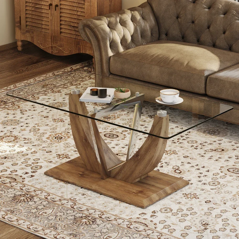 Modern minimalist clear tempered glass coffee table, wooden MDF legs and stainless steel decorative columns.