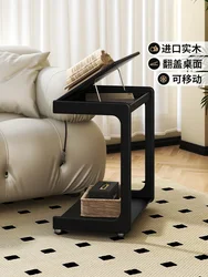 A few black movable C-shaped corners near the solid wood sofa, a few flip-top bedside tables, a small tea table with