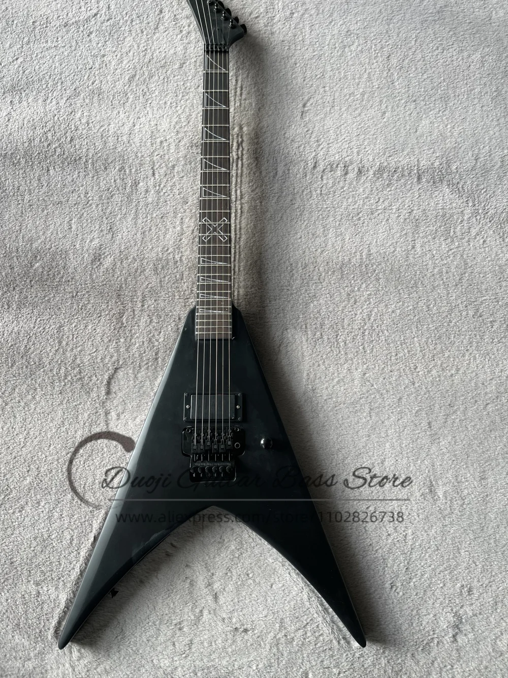Matte black guitar, black tremolo bridge, horn inlays on the fingerboard, maple neck set in solid body, sealed pickups.