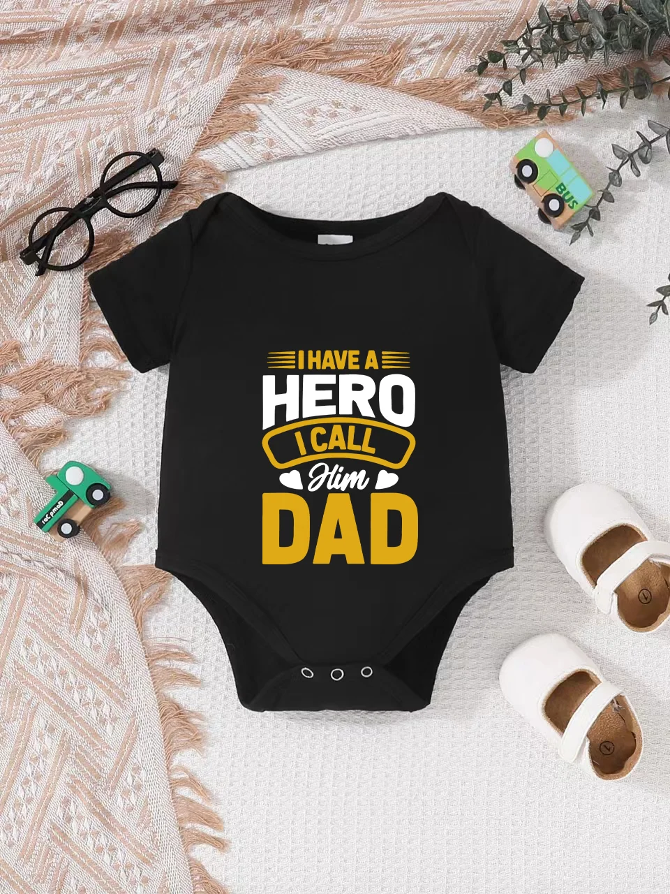Playful letter-printed baby short-sleeve triangle bodysuit. Button closure for easy dressing