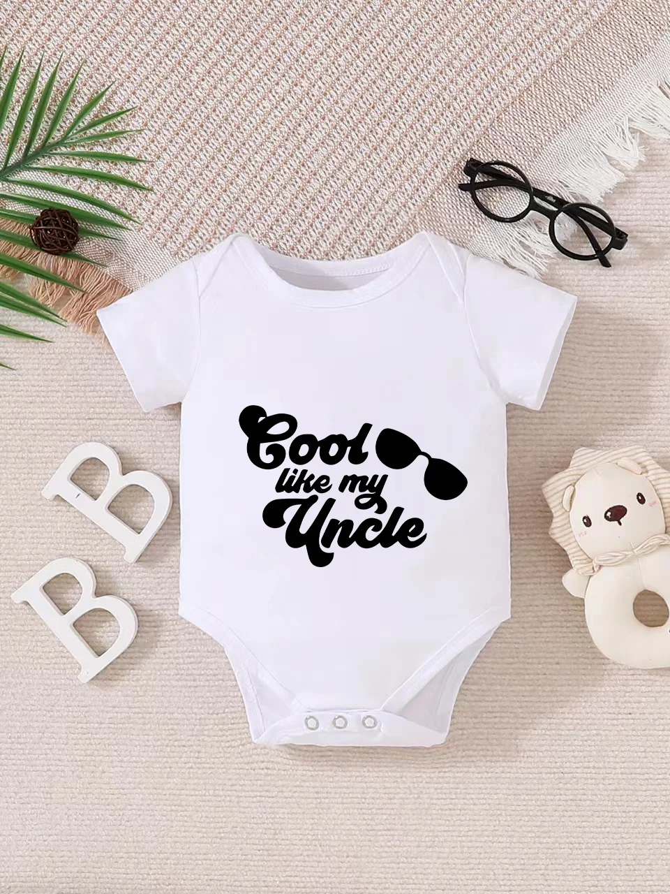Playful letter-printed baby short-sleeve triangle bodysuit. Button closure for easy dressing, machine washable