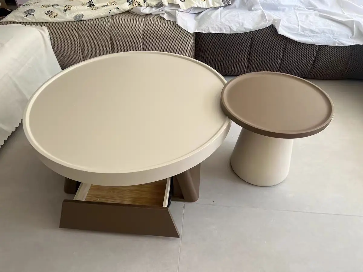 A combination of small units in the living room, family, cream style circular coffee table, antique style table, large and small