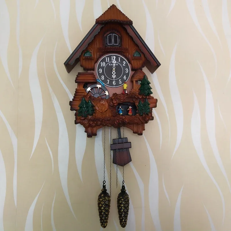 European cuckoo wall clock cooing and telling the time, light control on the hour, telling the time in living room, children