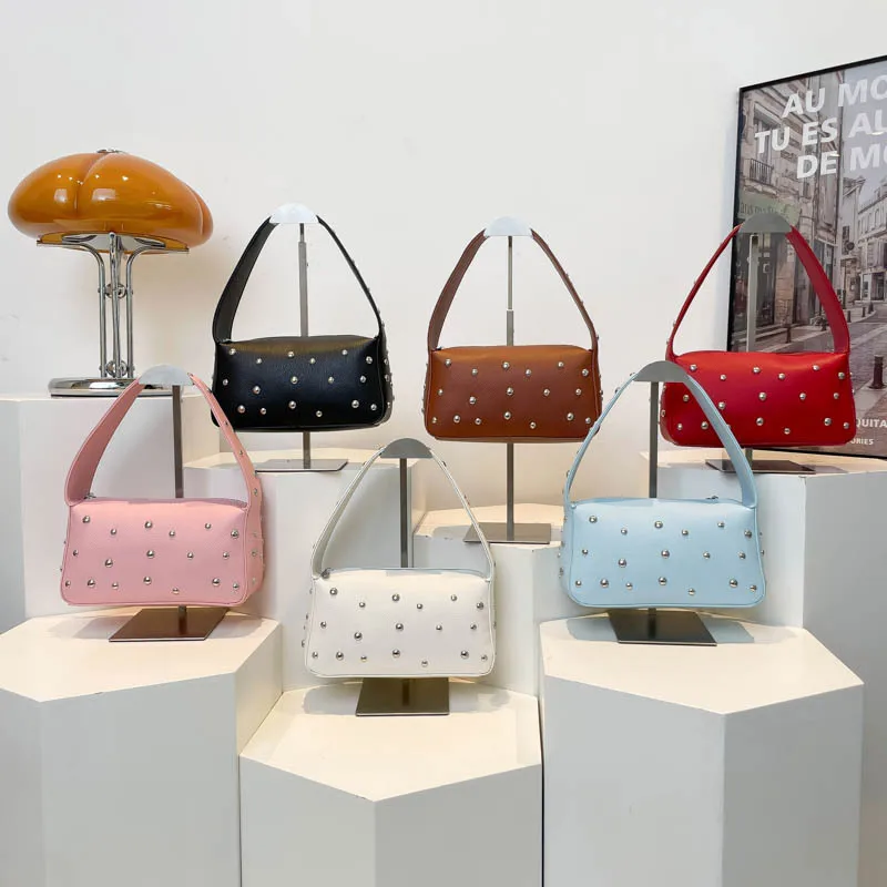 

The Studded Baguette Bag. This uniquely European square tote combines edgy design with sophisticated urban style.