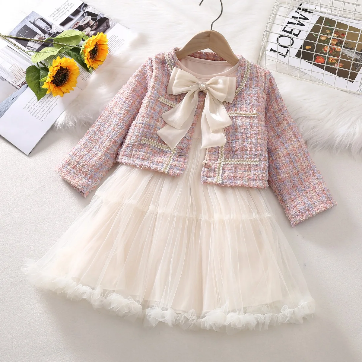 trendy and stylish two-piece autumn suit dress for a little girl with a chanel-style bow