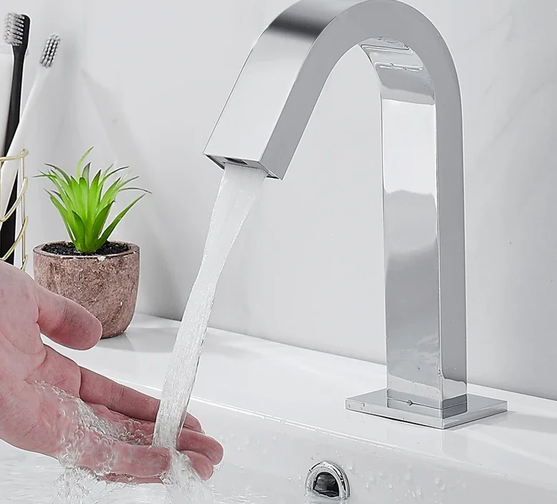 Full-automatic induction faucet with single cold and hot faucet on the washroom counter.