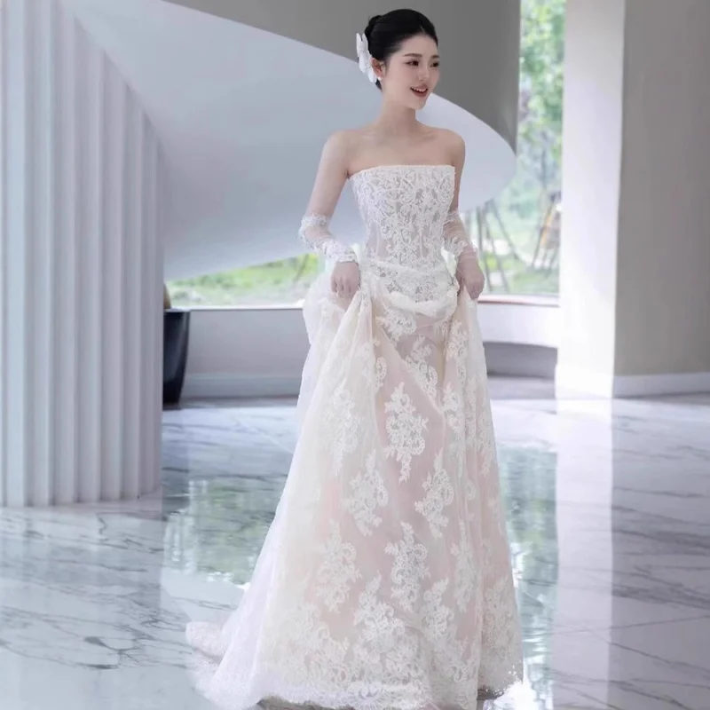White strapless light wedding dress with a small train, ethereal bridal evening gown, high-end elegant dress