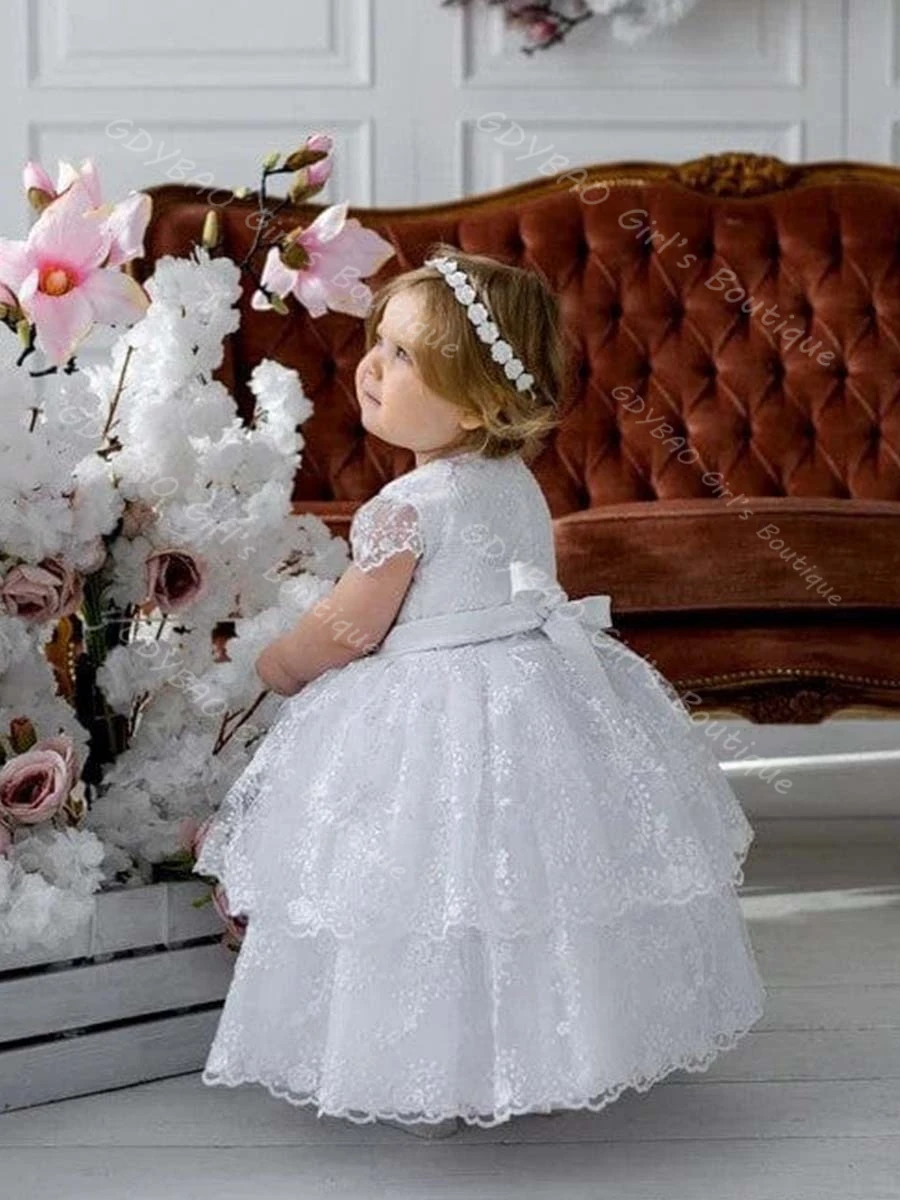 فستان التعميد من الدانتيل المتدرج للأطفال الصغار بأكمام قصيرة وشاحات على شكل فيونكة فستان التواصل المعمودي 0-6T للأطفال مخصص على شكل زهرة للفتيات فستان الحفلات