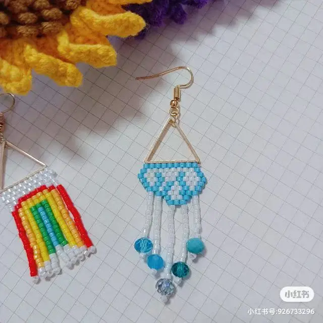

Beaded earrings Tassel Rainbow Hand knitting Wind and rain Design Symmetry Bohemia Alloy Geometry Tide Simple Rice bead earrings