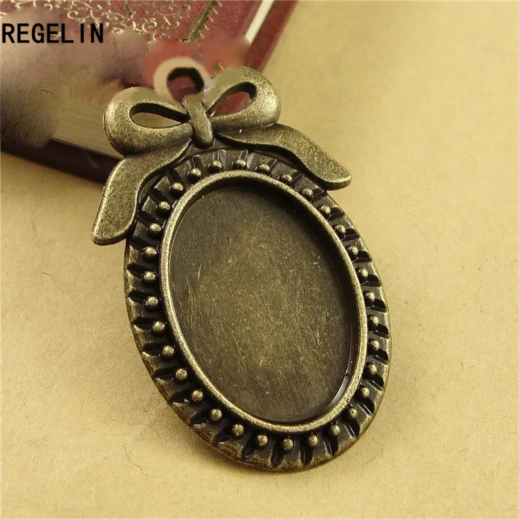 REGELIN 10pcs/lot Two color filigree bowknot cameo cabochon base setting pendant tray 18*25mm Blanks For DIY Jewelry Making