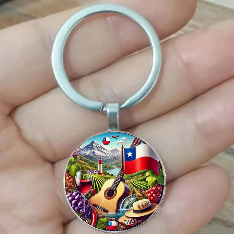 

Chilean Andes mountain vintage keychain, made of zinc alloy, featuring the Andes mountain range, guitar, wine glass, and mountai