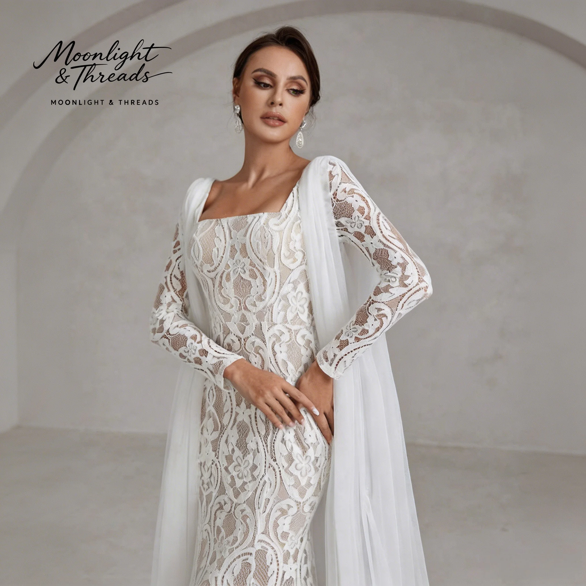 

White lace square-neck long-sleeve mermaid formal wedding gown with embroidery and a floor-length cape