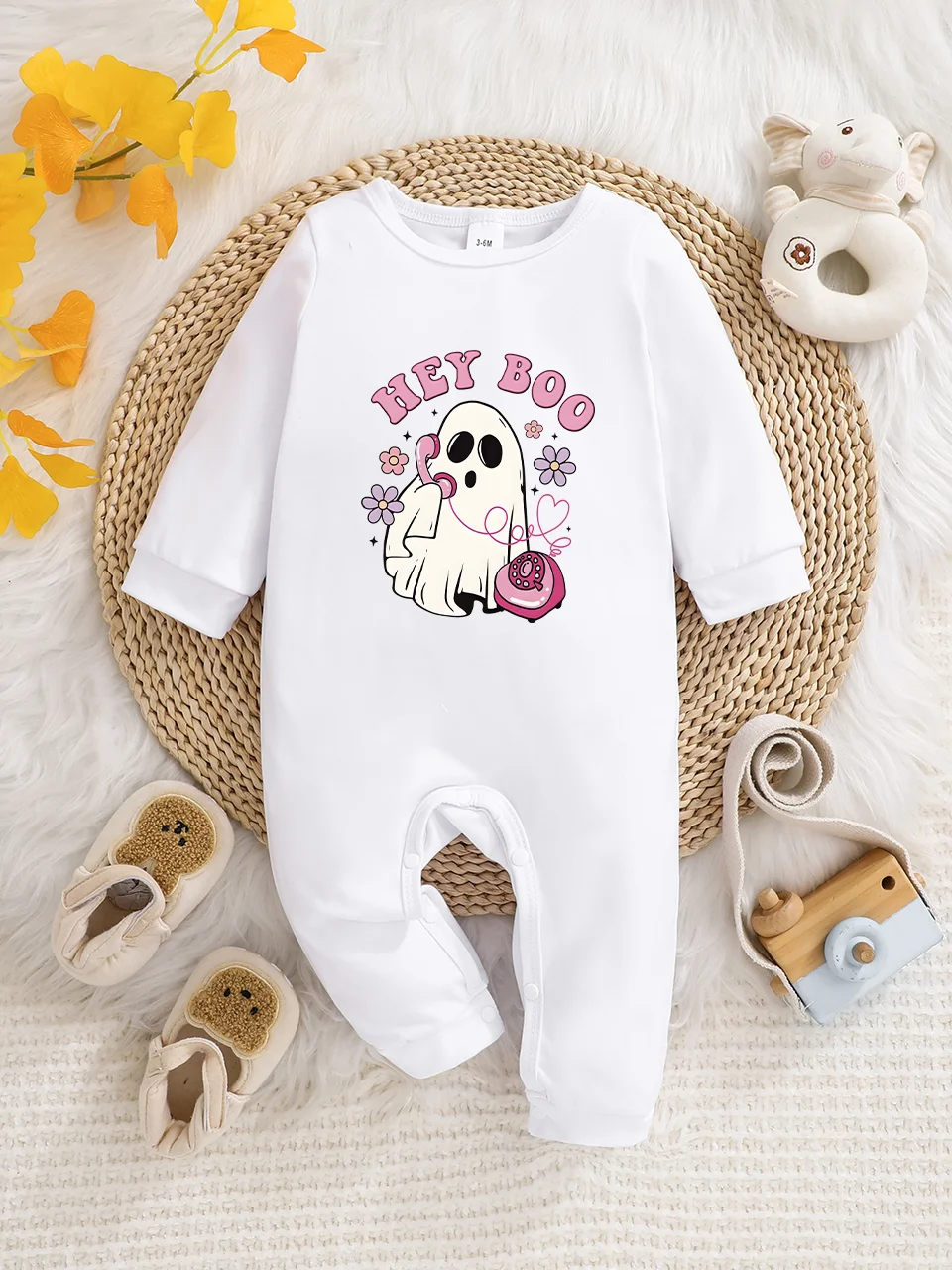 A baby long-sleeved onesie with interesting letter prints. It features a buttoned design for easy putting on and taking off, and