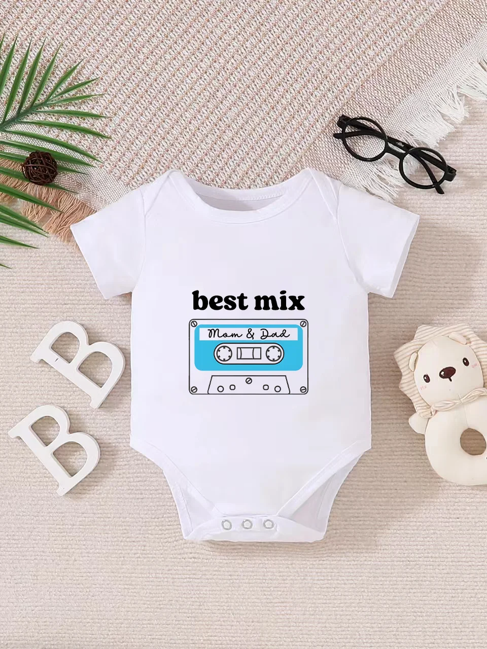 Playful letter-printed baby short-sleeve triangle bodysuit. Button closure for easy dressing, machine washable