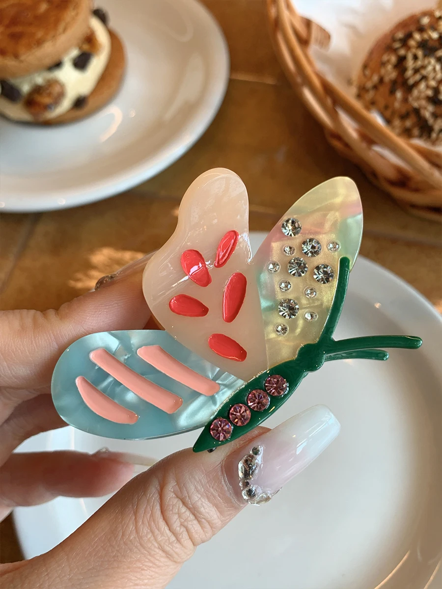 

Colorful romantic butterfly grab clip, high-end foreign fashion light luxury rhinestone half-tie shark clip
