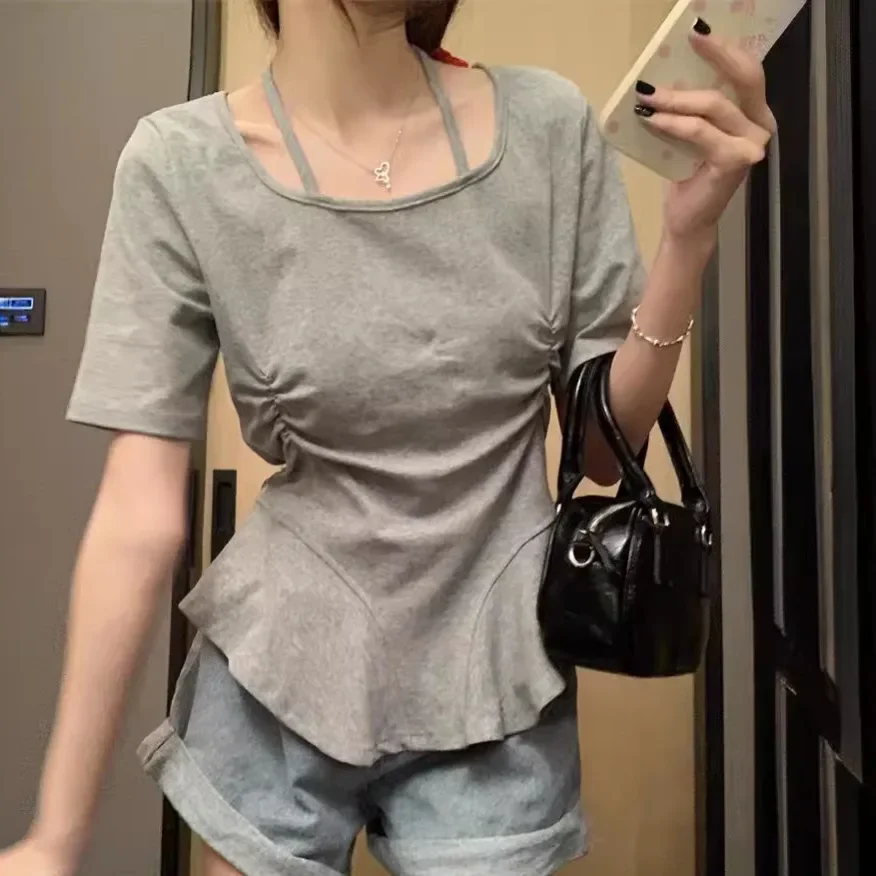 

Short-sleeved T-shirt women's 2024 summer new fashion design sense hanging neck sling irregular waist bottoming niche top.