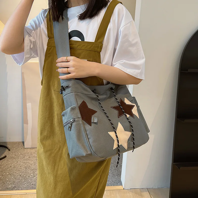 

Horizontal square shoulder backpack collision color five-pointed star large capacity hand strap strap strap canvas bag