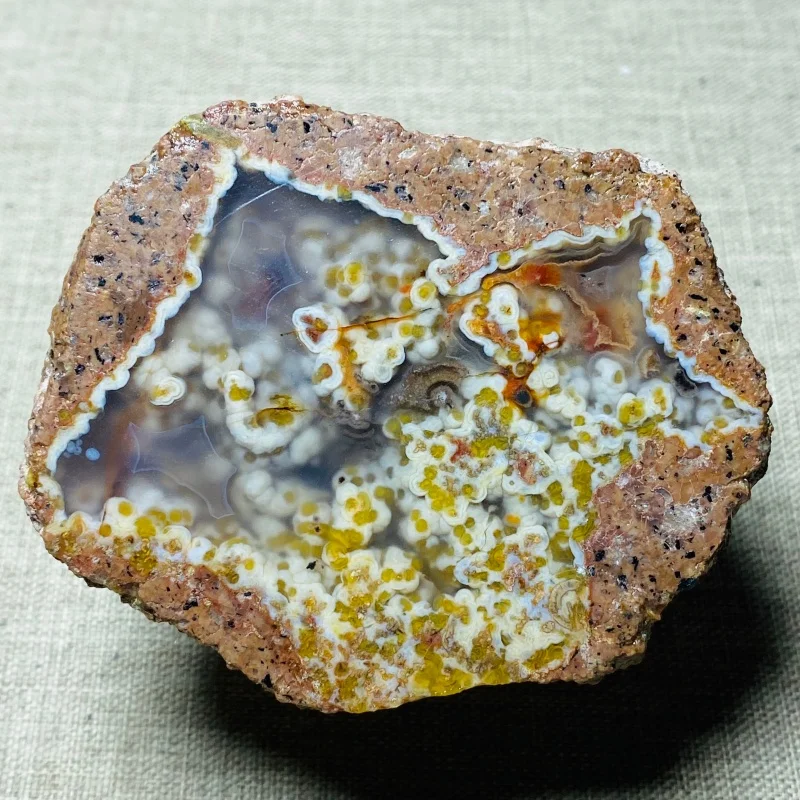 

Colorful and natural Brazilian agate, with a warm brownish-red rock shell, formed by volcanic activity.