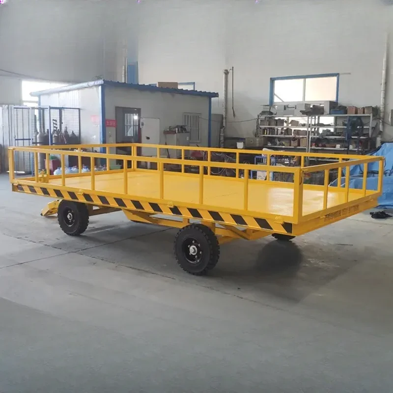 Towing a flatbed trailer for heavy-duty transportation in the factory area, with four wheels for turnover