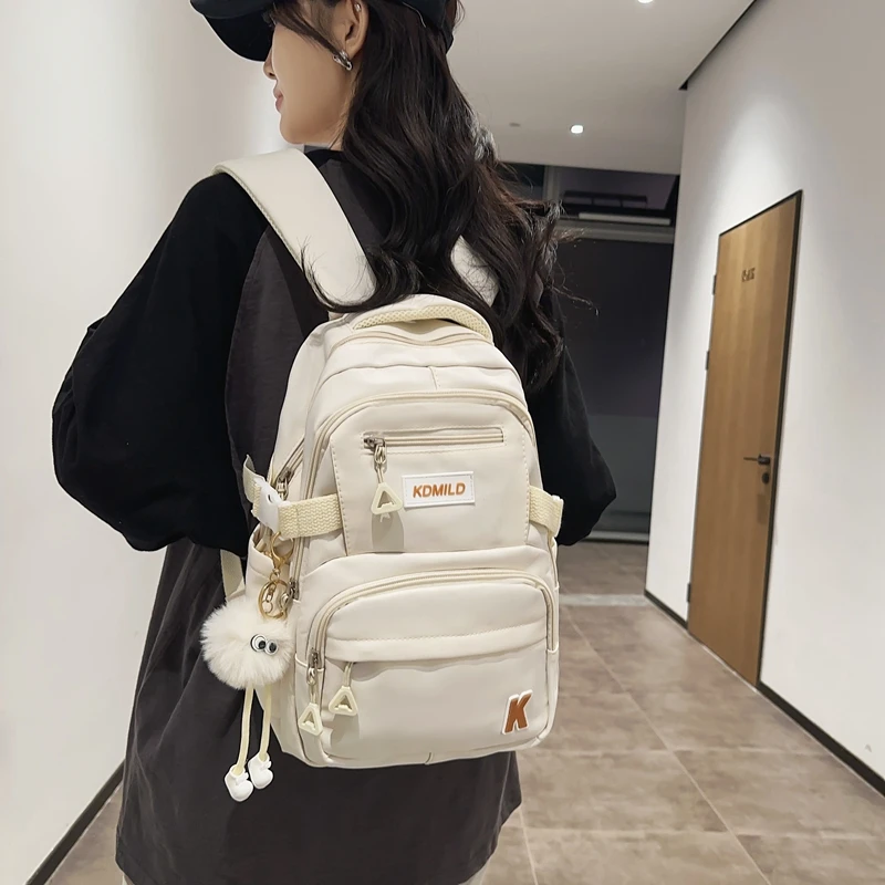 Name:A Stylish Cute Lightweight Backpack Solid Color Multi-pockets For Work Commuting Student School Bag With A Pendant