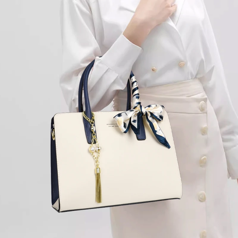 

Aidrani Two - Tone Leather Tote: Scarf Accent, Pearl - Tassel Charm & Elegance