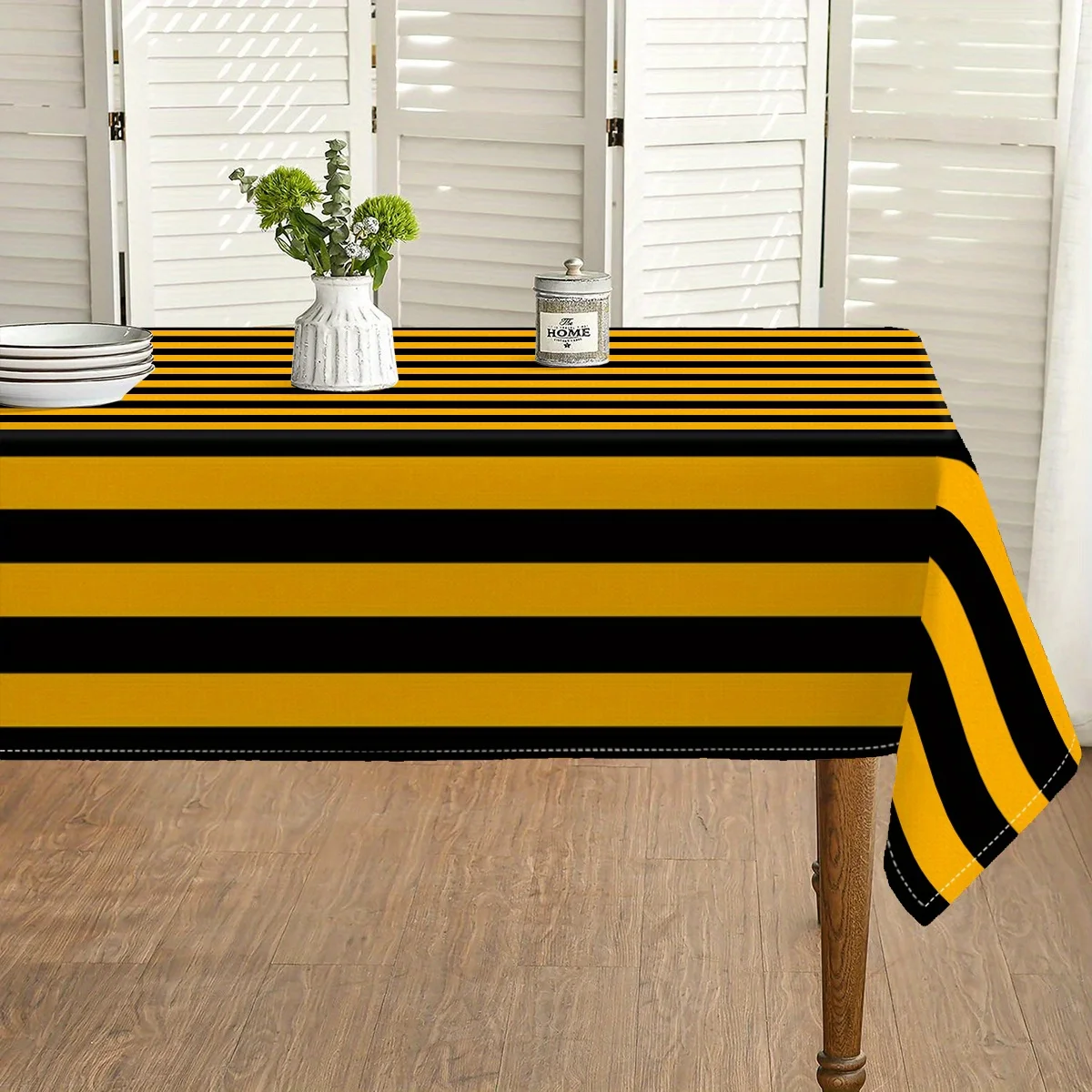 One black and yellow vertical striped rectangular tablecloth, made of polyester fabric with a 120g weight of twill weave.