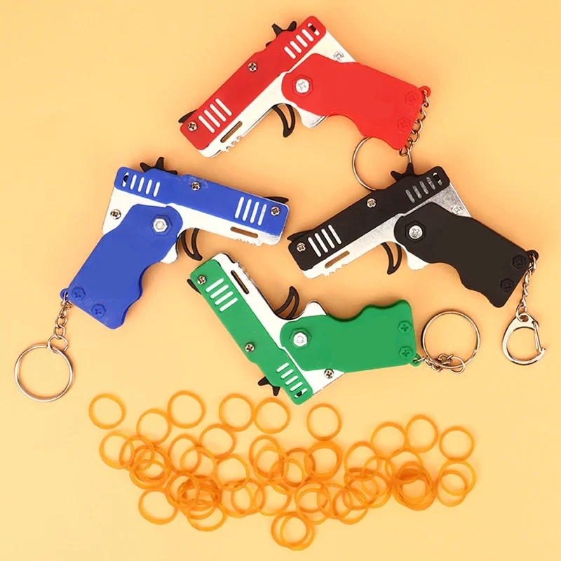 Mini keychain gun Rubber Band gun Toy gun Shooting Pistol Alloy Children's Outdoor Party Folding 7cm metal gun gift toy