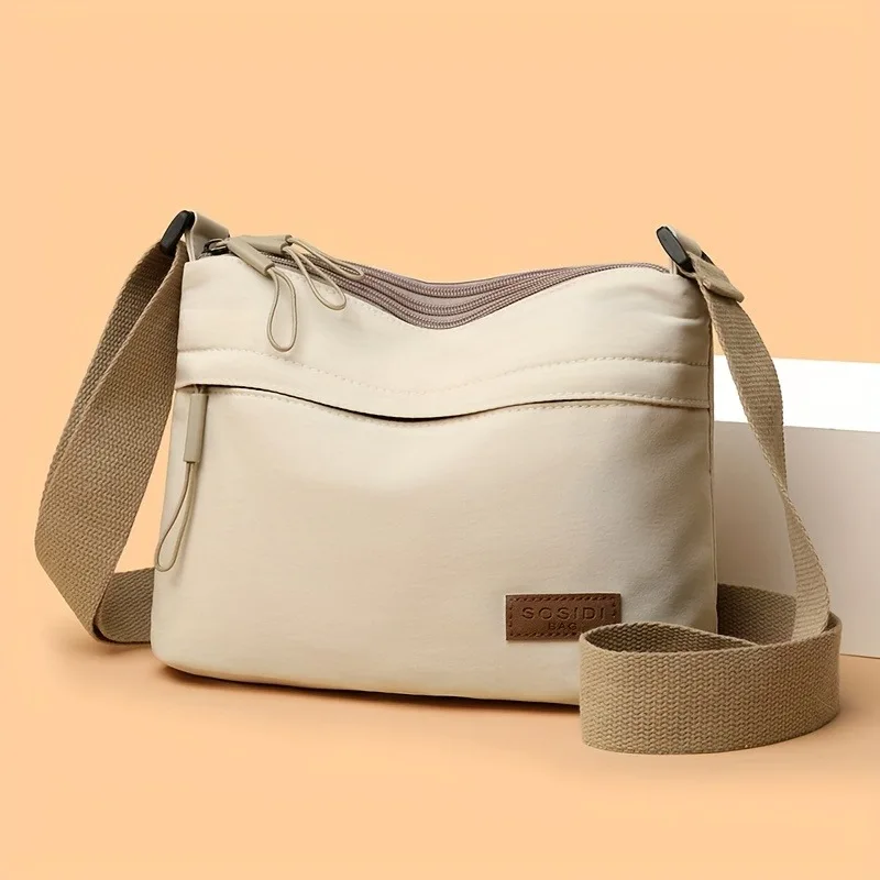 กระเป๋าผ้าแคนวาสสีพื้นเรียบง่ายสำหรับผู้หญิง กระเป๋าสะพายข้างแบบพกพาแฟชั่นกันน้ำอเนกประสงค์แบบใหม่