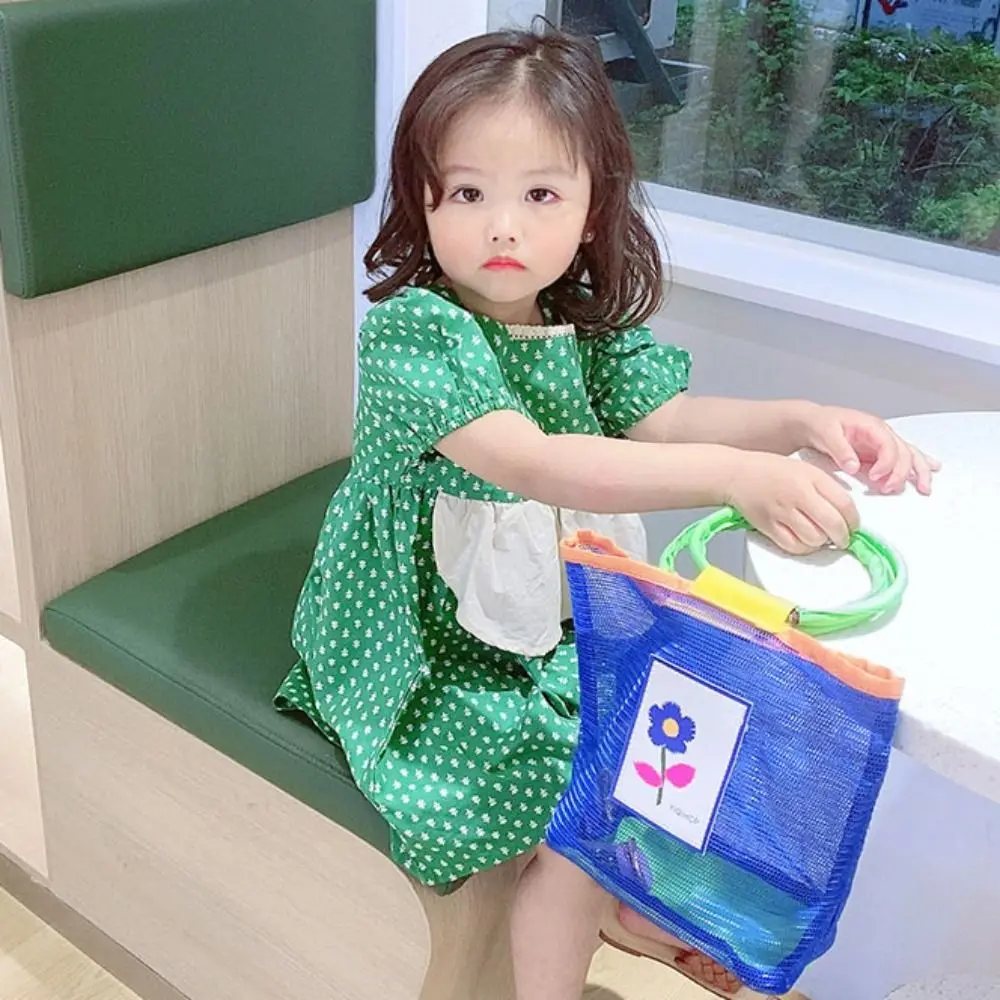 اللون الاصطدام شبكة حمل حقيبة شفافة قذيفة حقيبة التخزين الأطفال حقيبة يد الجوف خارج الأم الاطفال حقيبة شبكة حقيبة شاطئية السفر