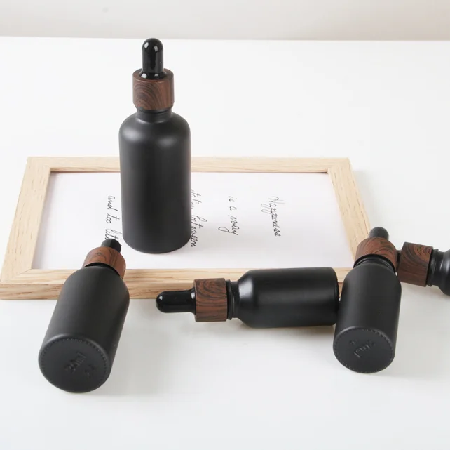 

100pcs 50ml Matt Black Glass Dropper Bottle Matt Black Cosmetic Cream Jar Glass Bottle With Plastic Wood Cap