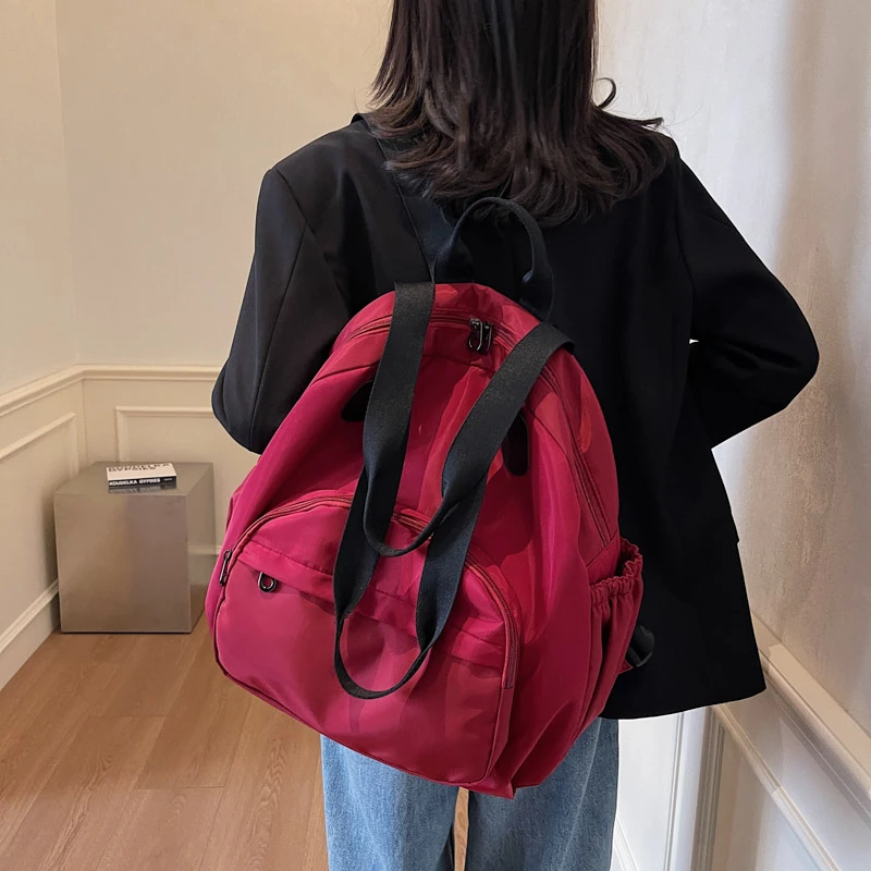 Mochilas para estudiantes de nailon de gran capacidad, colores sólidos, bolsas con cremallera a la venta, mochila escolar con bolsillo Interior versátil con cremallera 2025