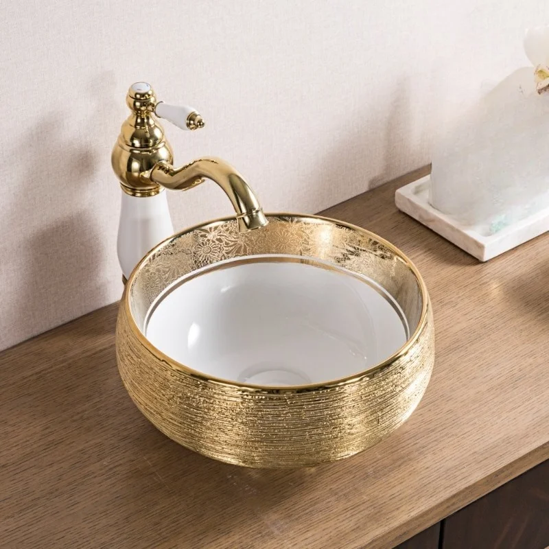 Electroplated gold dresser ceramic bathroom sink above small round countertop wash basin