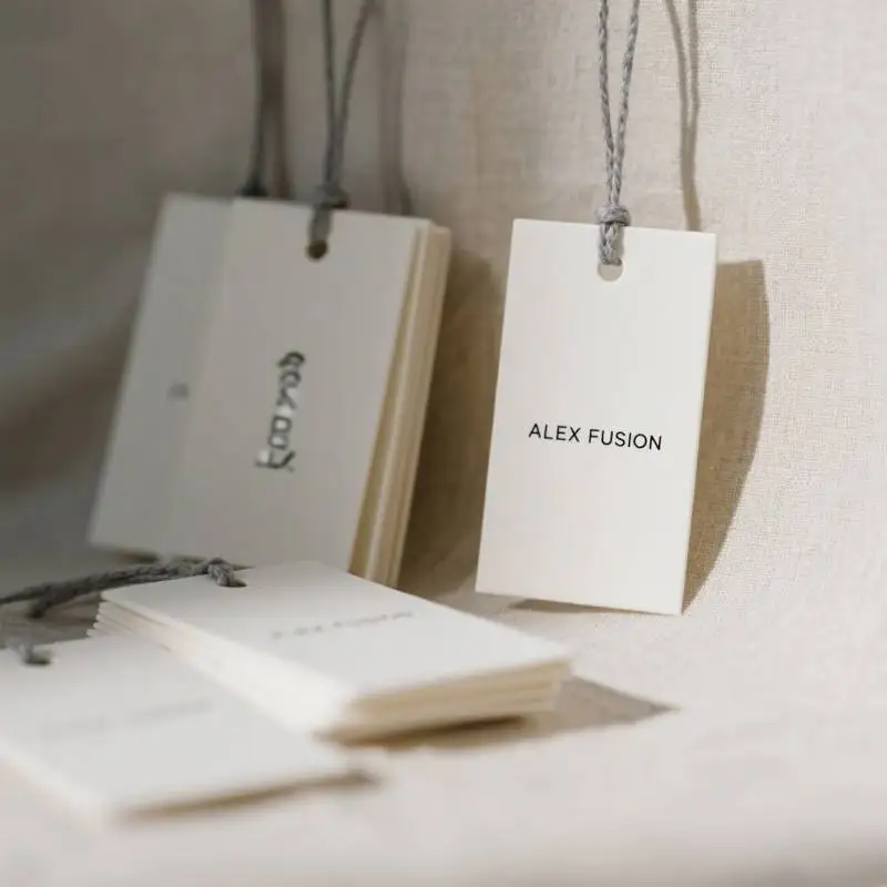 Wholesale Luxury Paper Hang Tags Custom UV Embossed Logo Personalized Brand Labels for Clothing Bags Shoes Accessories