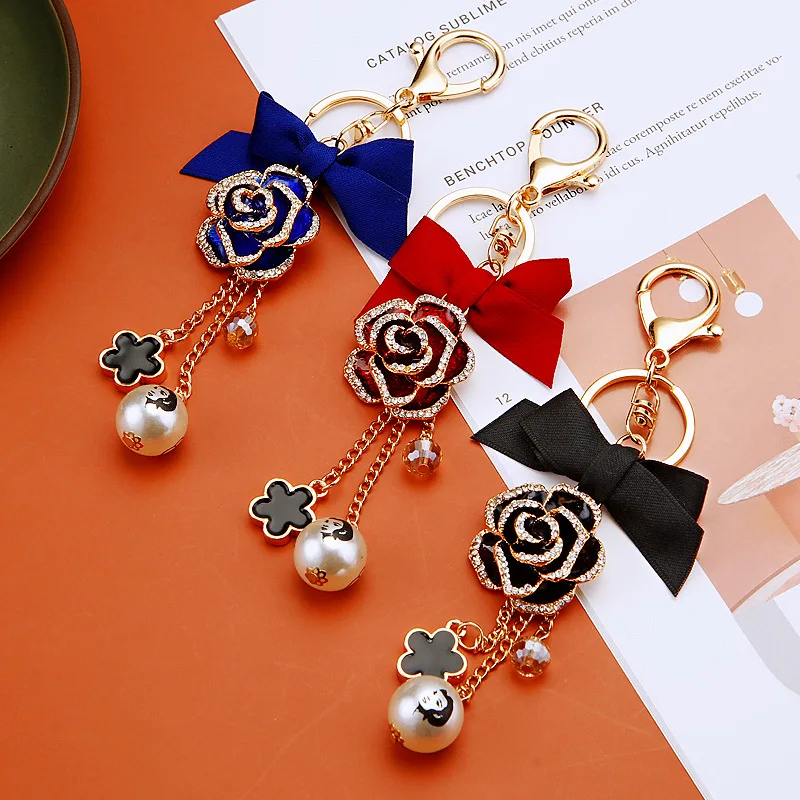 الأزياء القوس عالية Guishan الشاي زهرة سيارة المفاتيح حقيبة قلادة اللؤلؤ هدية صغيرة التبعي