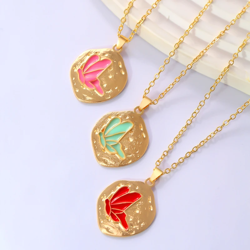 A necklace featuring an irregularly shaped circular design combined with butterfly drop-painting technique