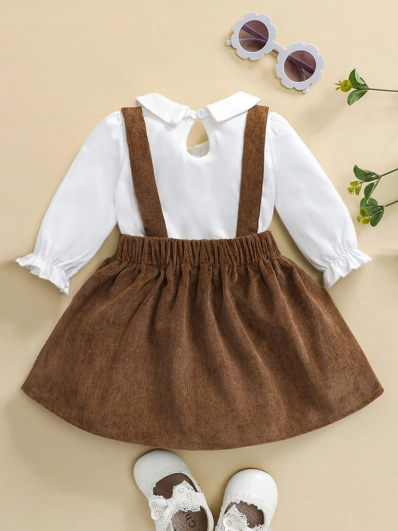 Baby girl autumn delicate style outfit with white doll collar top, brown corduroy shoulder strap skirt, family party set