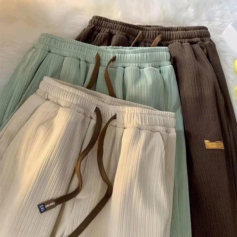 Pantaloni da uomo in seta di ghiaccio a coste stile coreano pantaloni Casual ad asciugatura rapida tasche con coulisse pantaloni lunghi sportivi