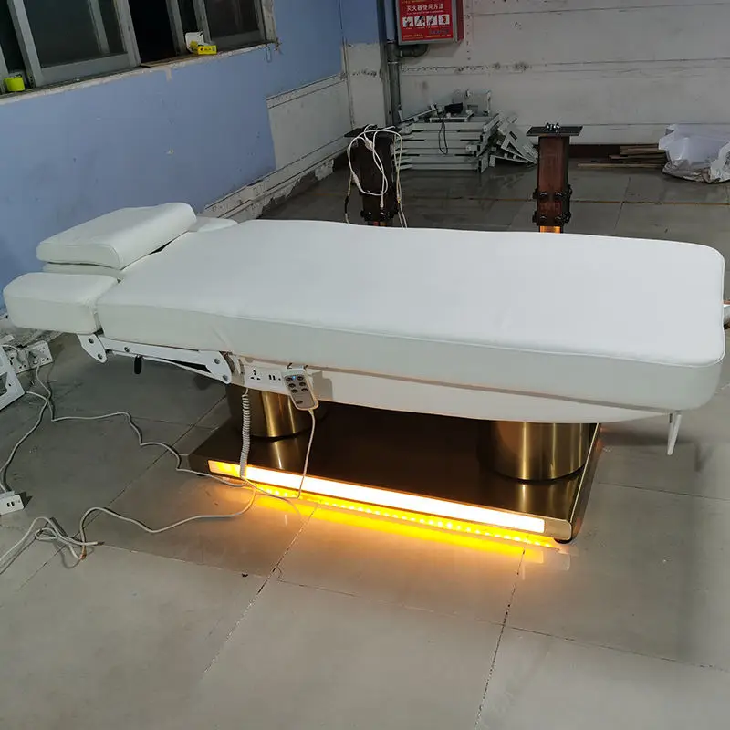 Electric Massage Bed With Metal Frame And Buff Upholstery For Professional Beauty Salon Spa Use