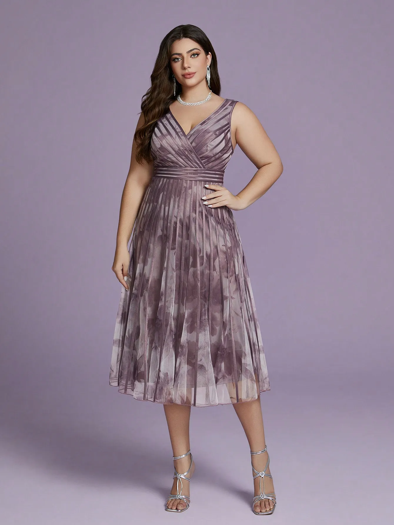 A high-end evening dress with a sleeveless printed chiffon top and wide slits at the hem.