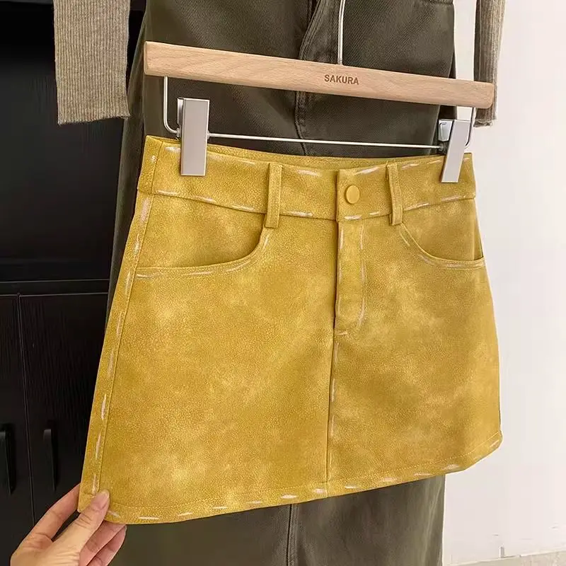 

y2k yellow PU leather skirt for women in autumn and winter, slim waist A-line spicy girl short tight fitting hip hugging skirt