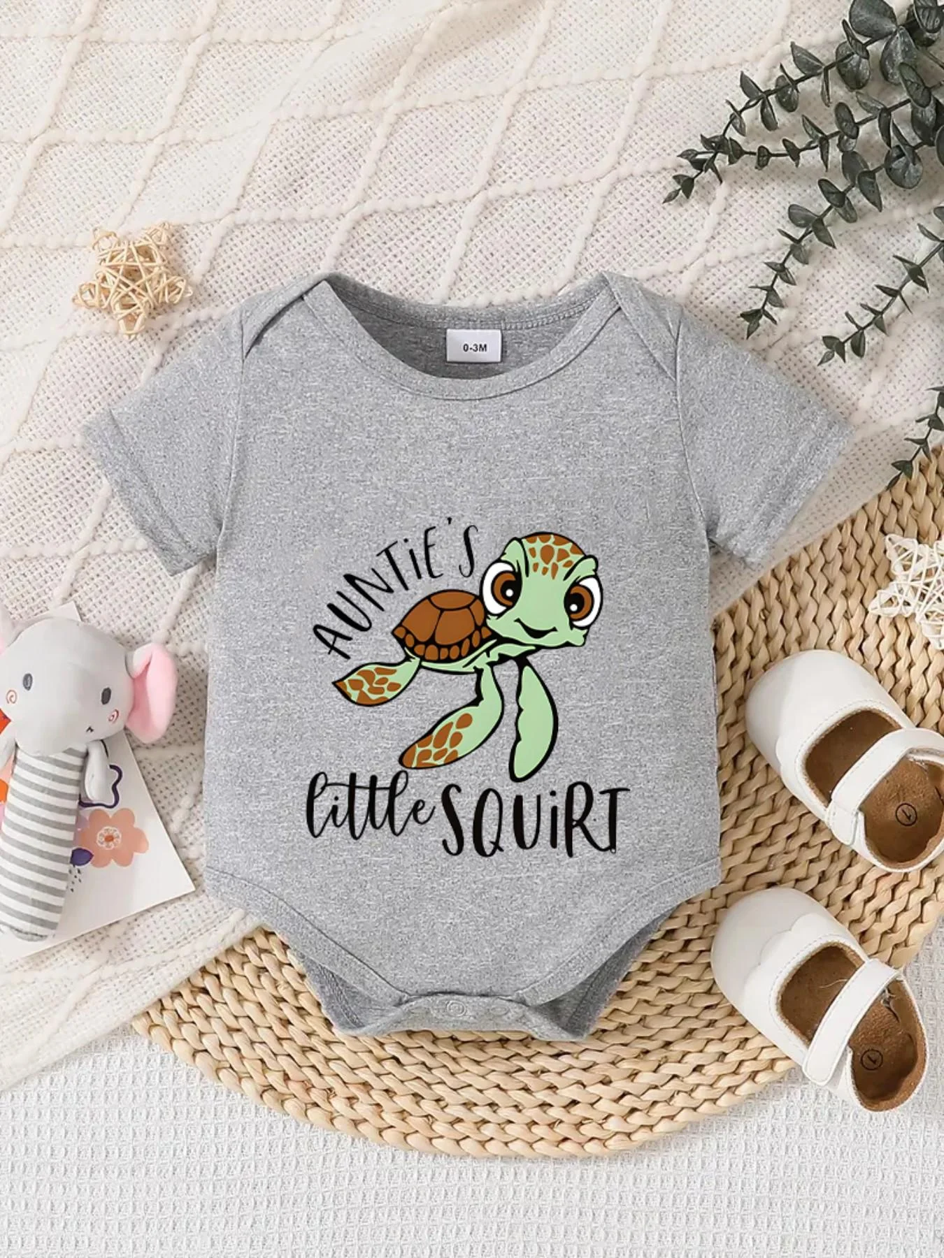 Playful letter-printed baby short-sleeve triangle bodysuit. Button closure for easy dressing