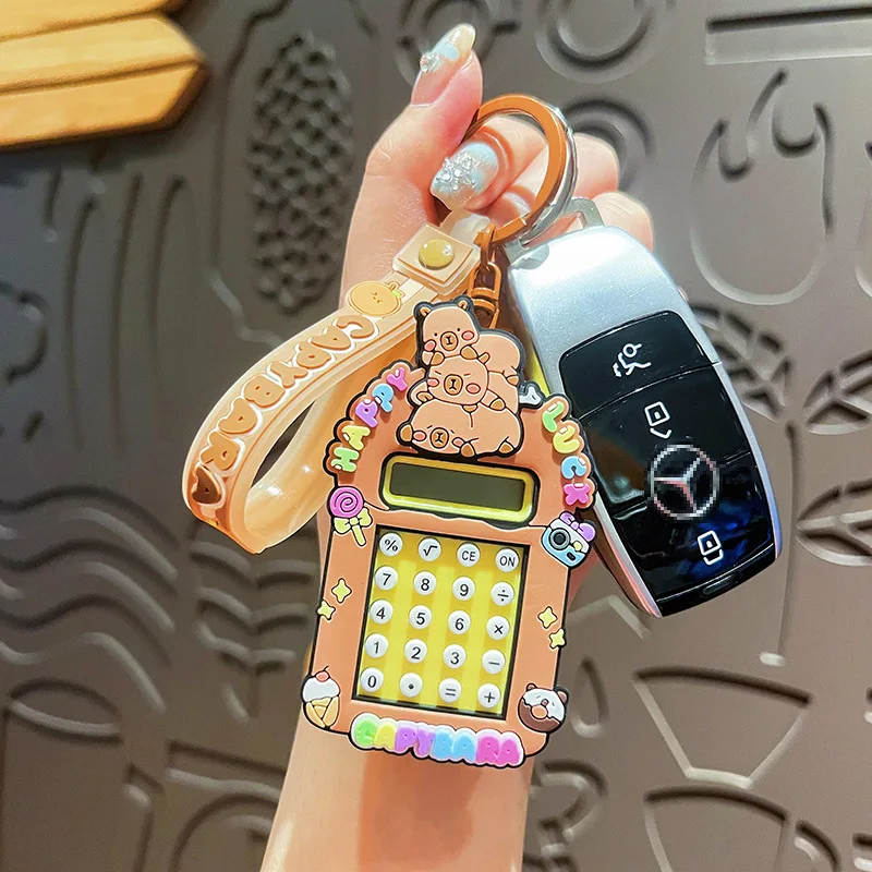 2025 nuevo llavero de calculadora Capibala lindo llavero de capibara de dibujos animados estudiante mochila colgante temporada escolar pequeño regalo