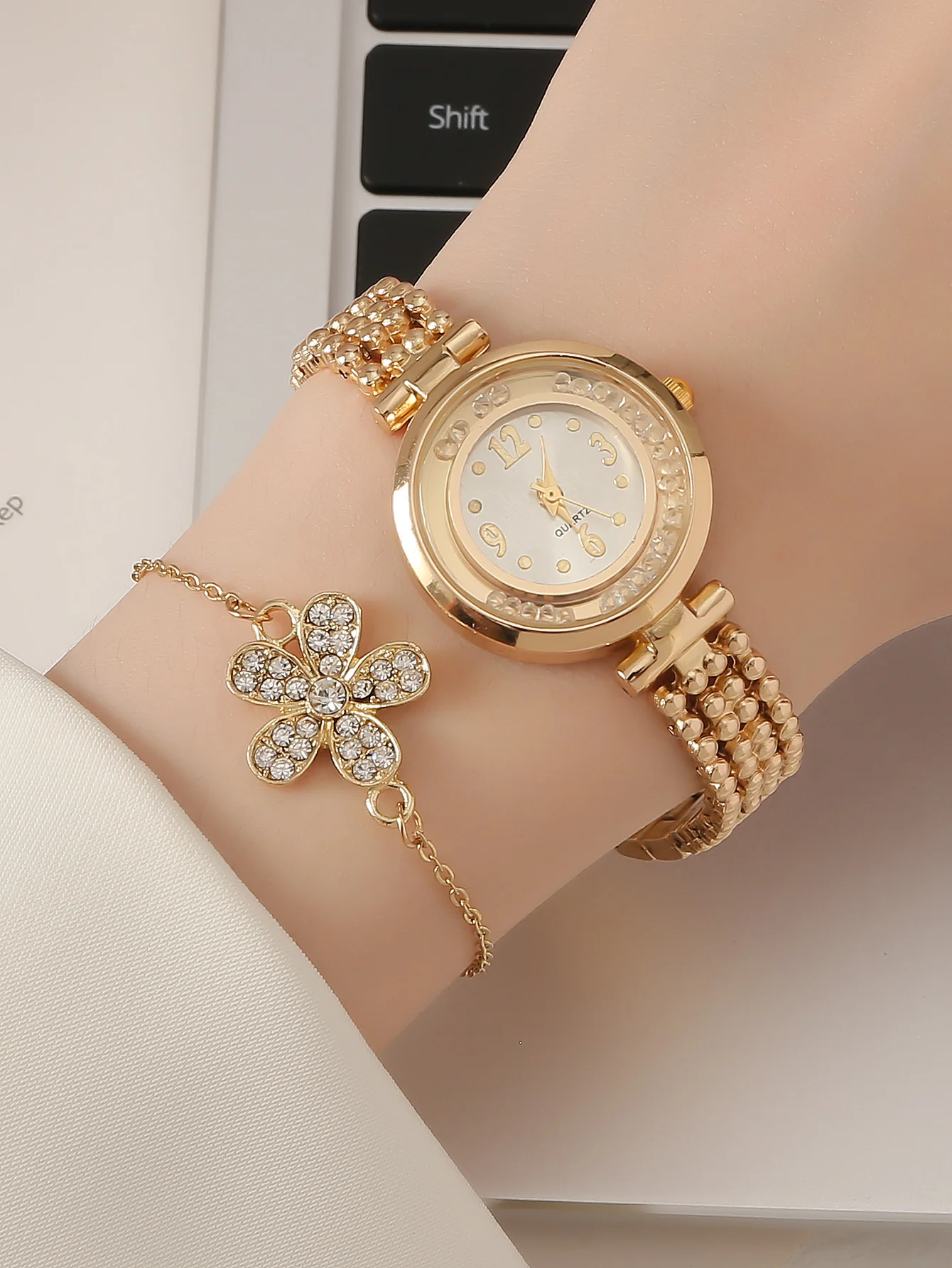 A Gold Women\'s Classic Fashion Quartz Watch With A Ball Bracelet And A Rhinestone Plum Bracelet. Can Be Used For Daily Wear