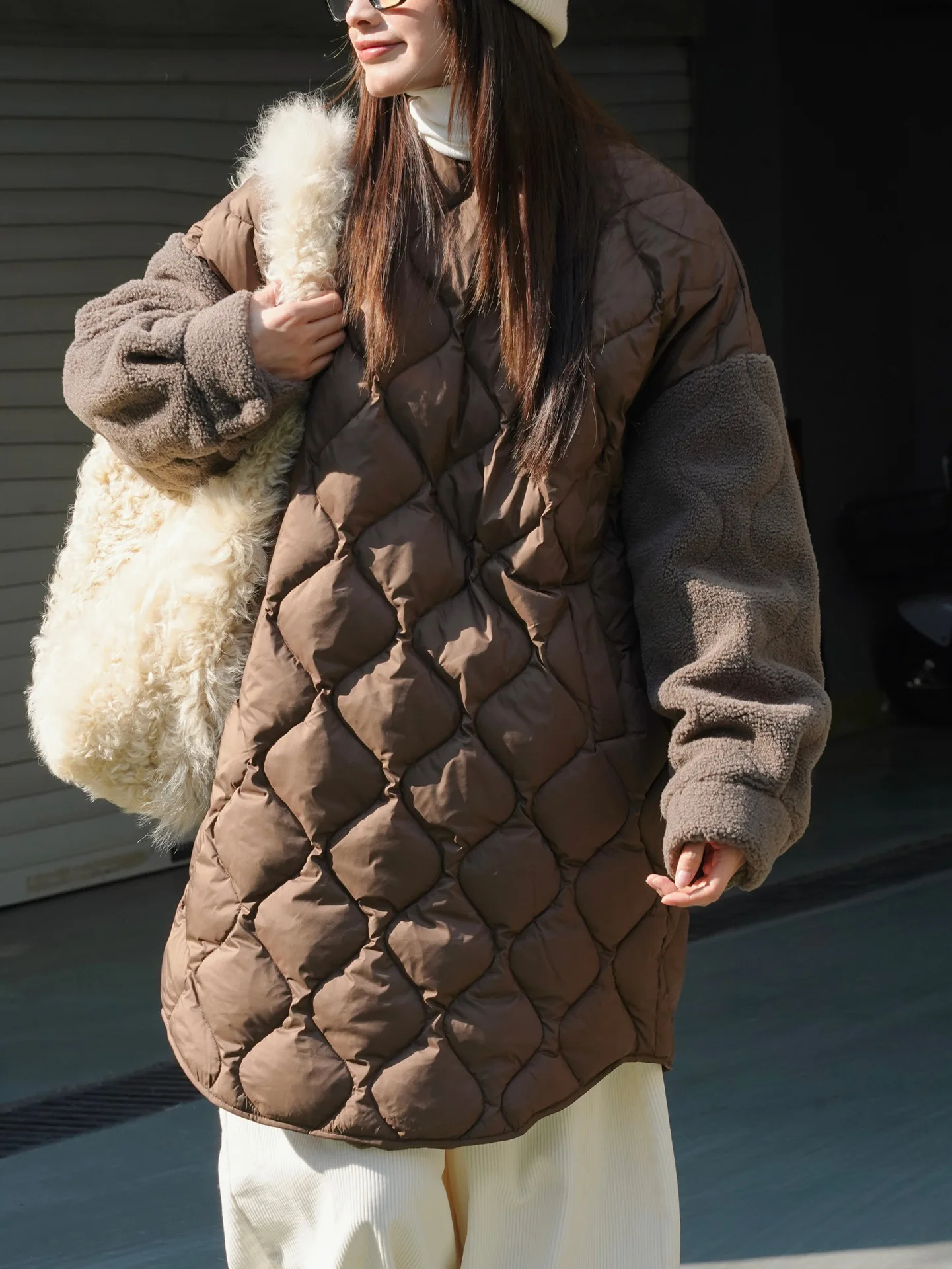 Autumn and winter women\'s casual solid color round neck long sleeved loose patchwork long down jacket