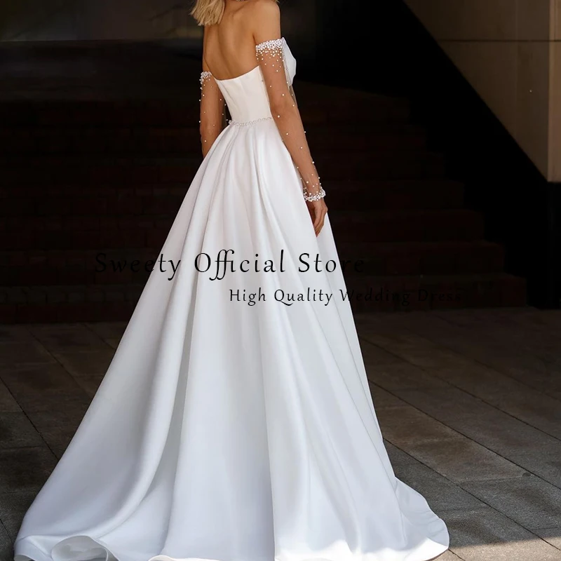 فستان زفاف مكشوف الكتفين من الساتان مع فيونكة لؤلؤ على شكل حرف a بدون حمالات وأكمام طويلة فستان عروس مخصص فيستدو دي نوفيا