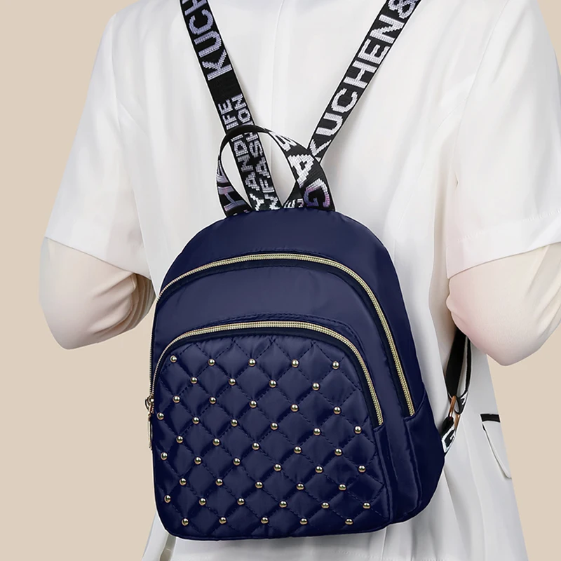 Neutral style backpack for men and women, with shoulder straps featuring letter prints and multiple pockets.